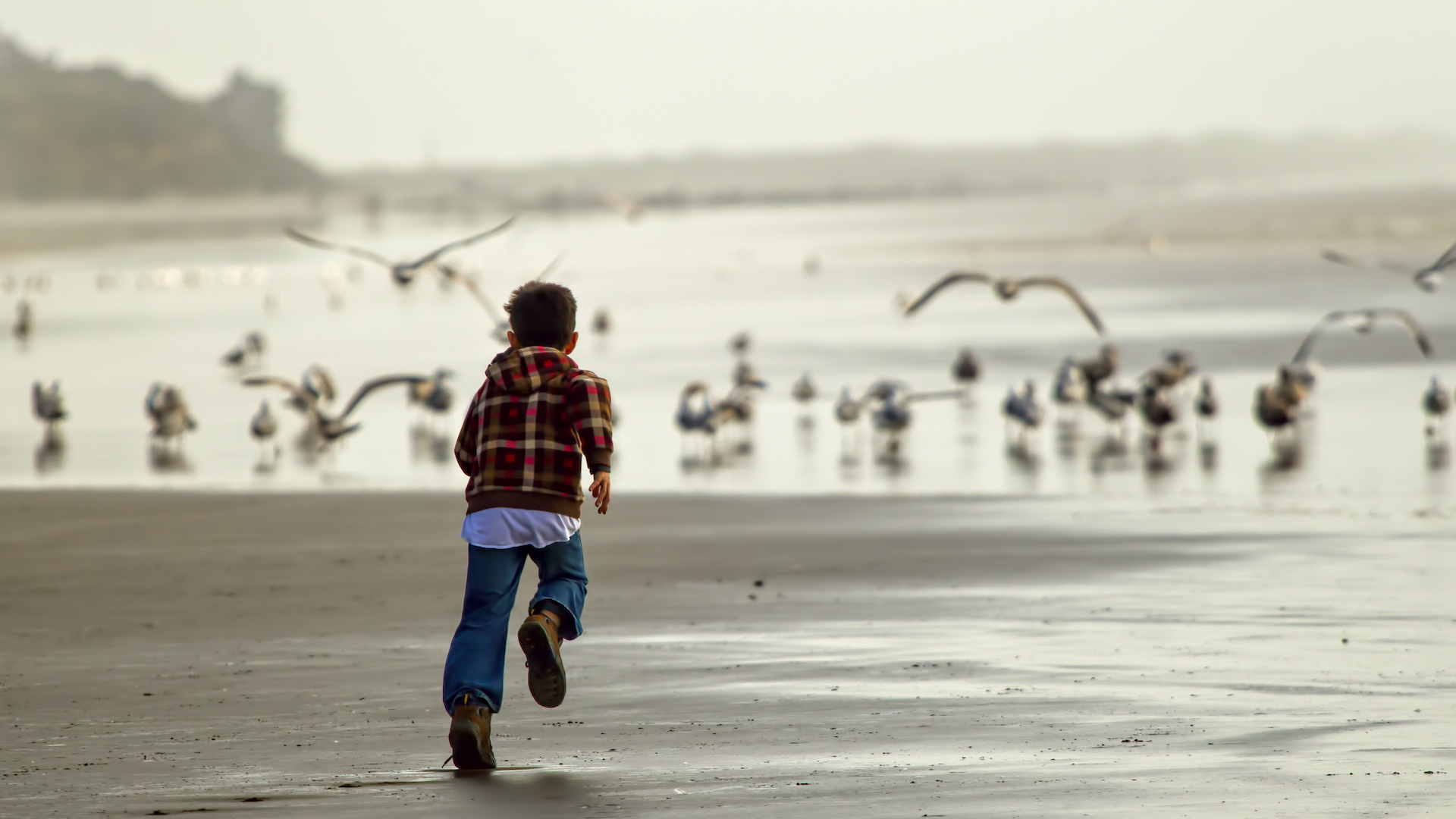 A child runs along the coast in Newport, Oregon.