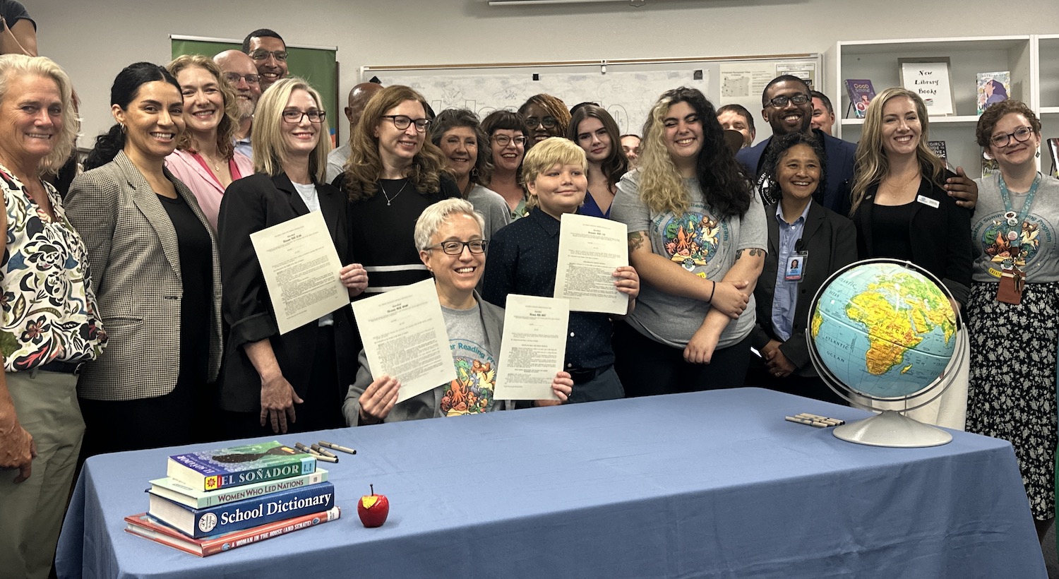 Gov. Tina Kotek celebrates the ceremonial signing of Senate Bill 141 at Prairie Mountain School in Eugene.