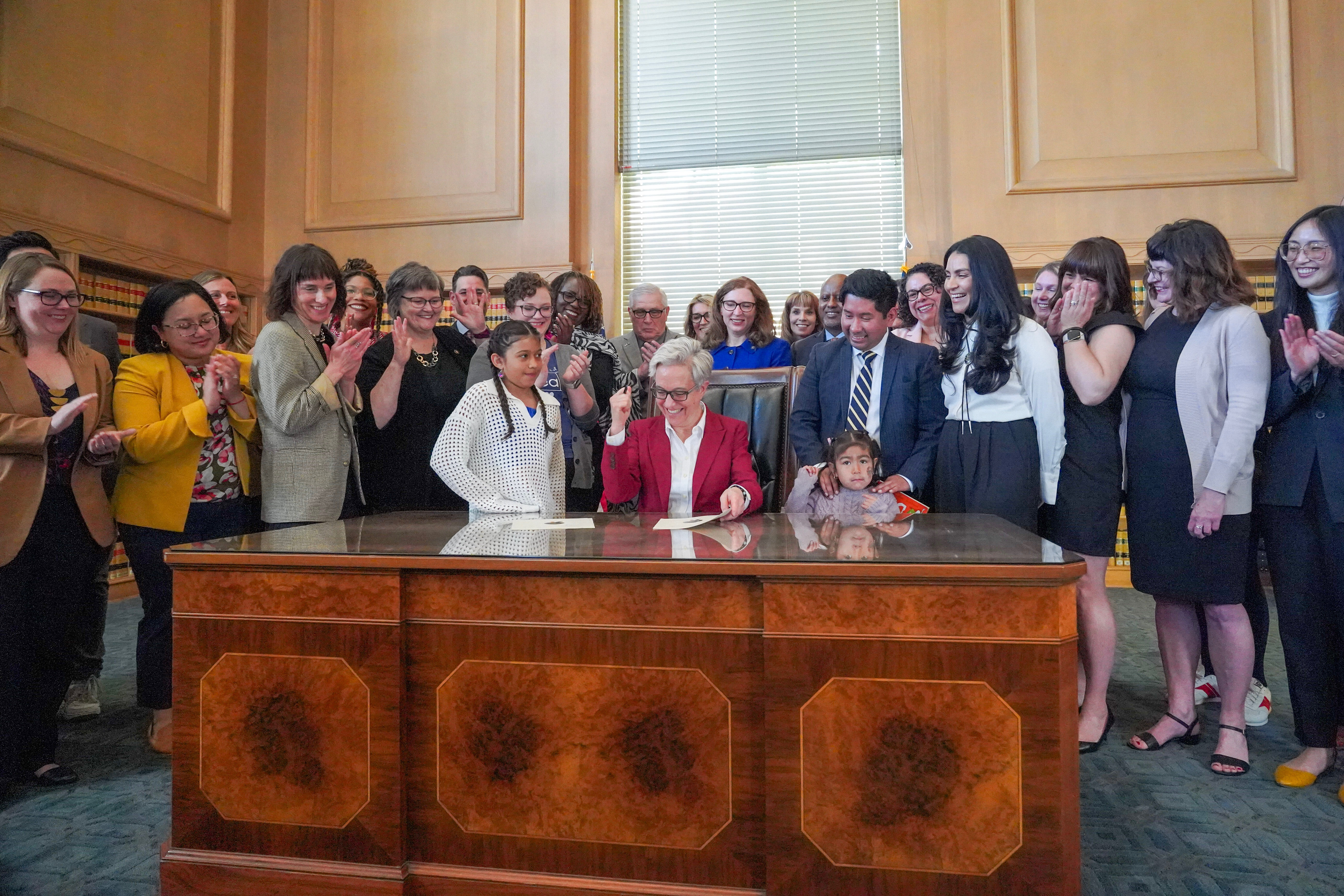 Gov. Tina Kotek, legislators, and supporters celebrate at the ceremonial bill signing for summer learning.